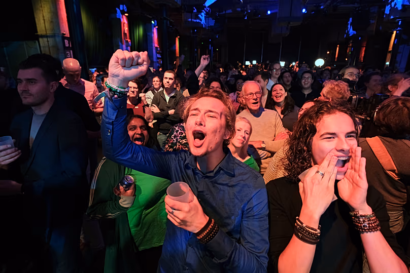 People react during early exit poll results for the PvdA party at an election venue during a general election in Rotterdam