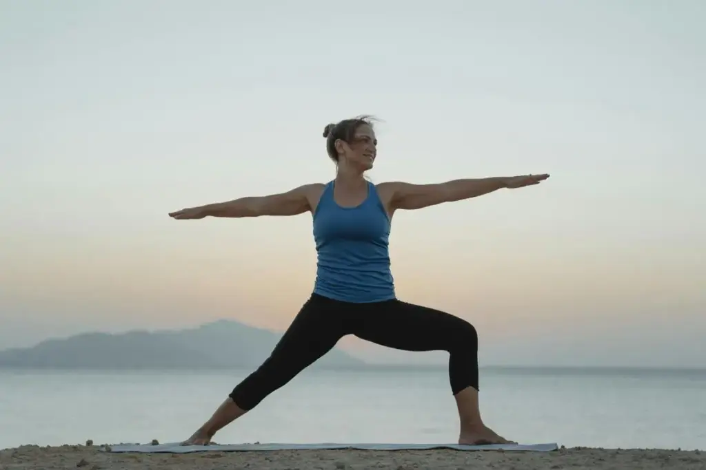 Woman practicing yoga on beach