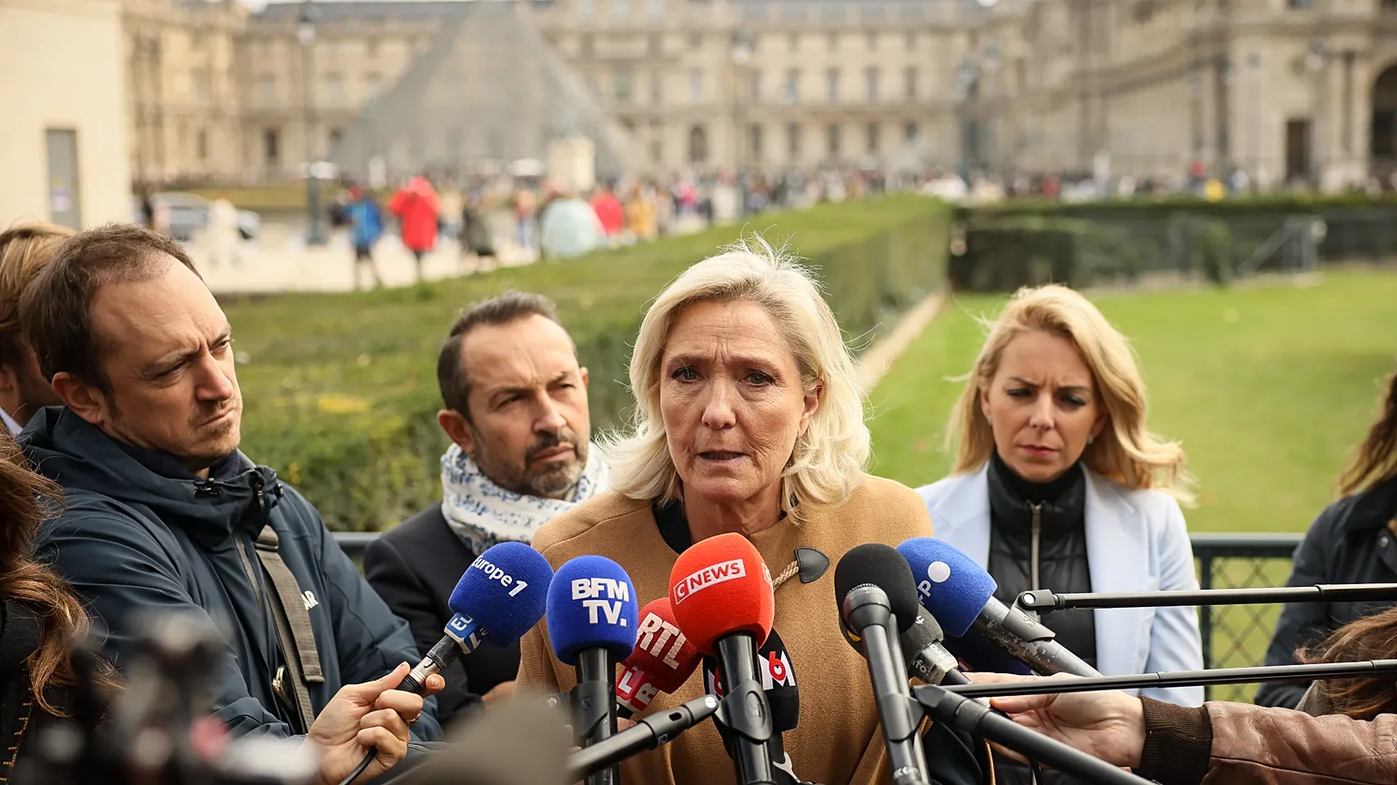 French far right leader Marine Le Pen answers reporters after visiting an exhibit beneath the Louvre museum Friday, Oct. 24, 2025 in Paris.