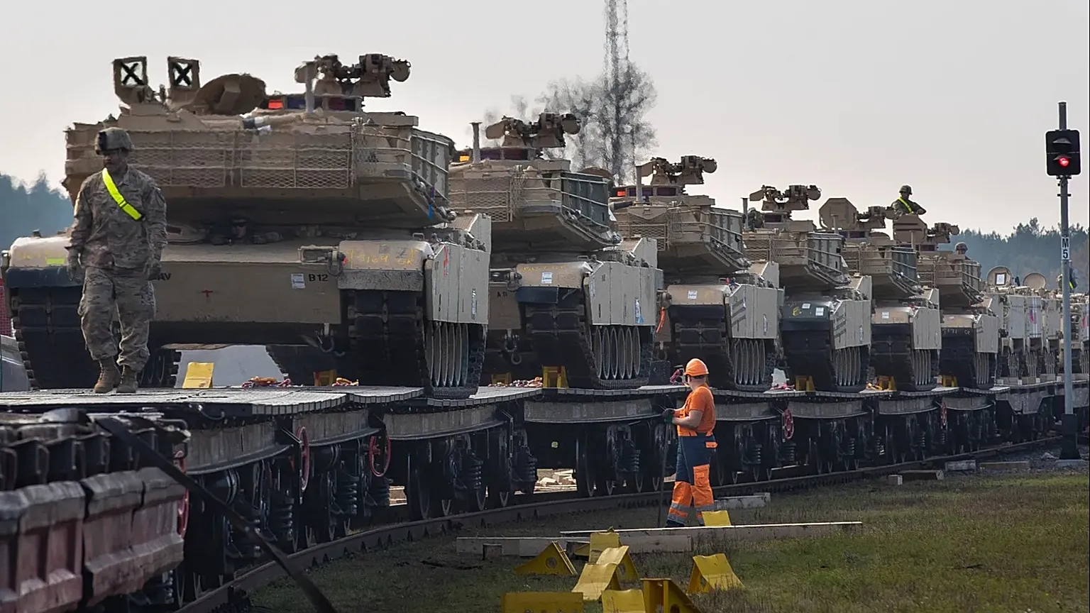 Abrams battle tanks from the US Army stand on rail cars as they arrive at the Pabrade railway station in Lithuania, 21 Oct 2019.