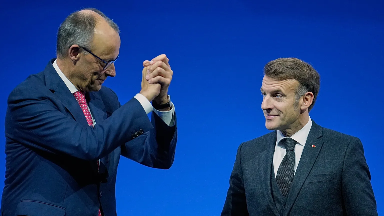 German Chancellor Friedrich Merz, left, reacts to French President Emmanuel Macron during a Summit on European Digital Sovereignty in Berlin, Germany, Tuesday, Nov. 18, 2025.