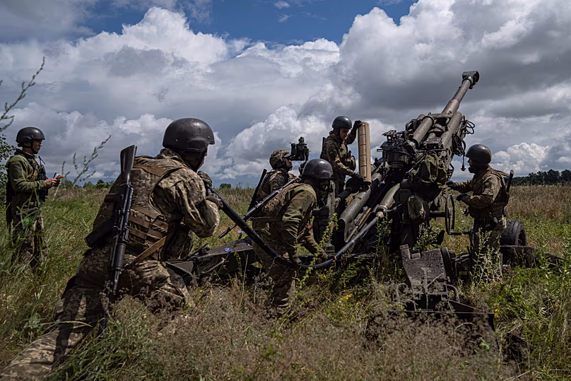 FILE - Ukrainian servicemen prepare to fire at Russian positions from a U.S.-supplied M777 howitzer in Kharkiv region, Ukraine, July 14, 2022. 