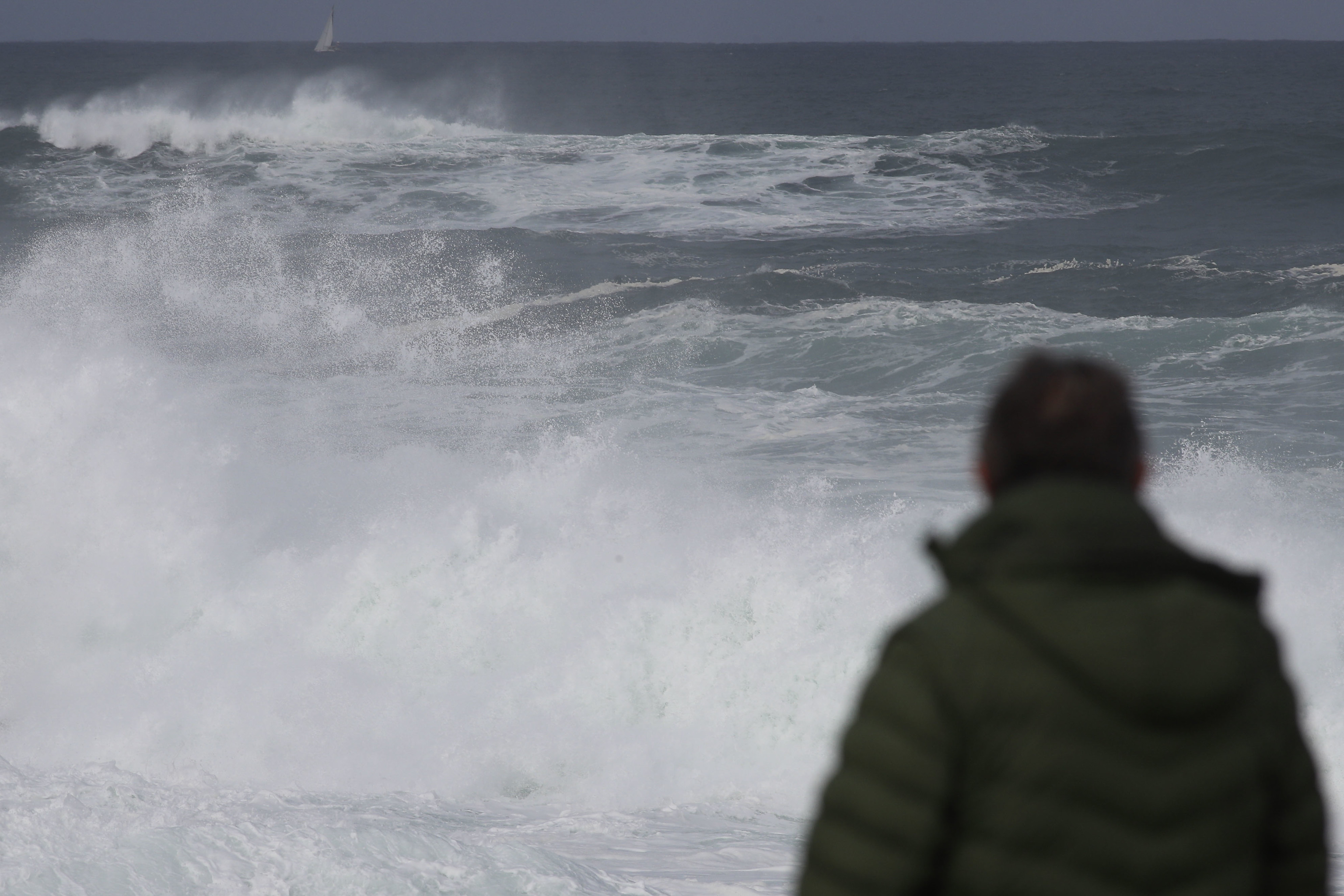 Un hombre observa las potentes olas en Burela (Lugo).