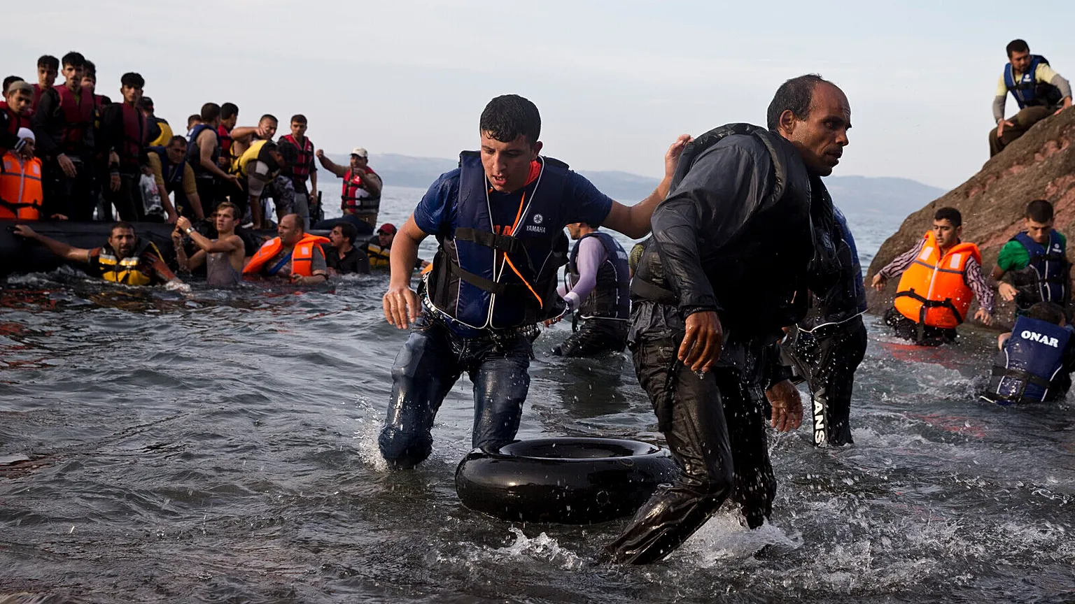 Migrants and refugees arrive on a dinghy after crossing from Turkey to Lesbos island, Greece, Sept. 9, 2015. 