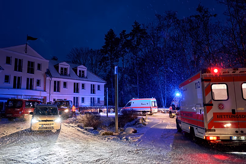Emergency vehicles from the aid organization "Die Johanniter" pick up residents of a retirement home in Berlin, Germany, Saturday, Jan. 3, 2025, during a power cut.