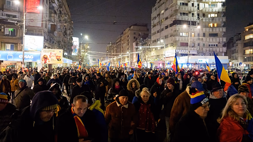 People march to protest government austerity measures in Bucharest, Romania, Thursday, Jan. 15, 2026. (AP Photo/Andreea Alexandru)