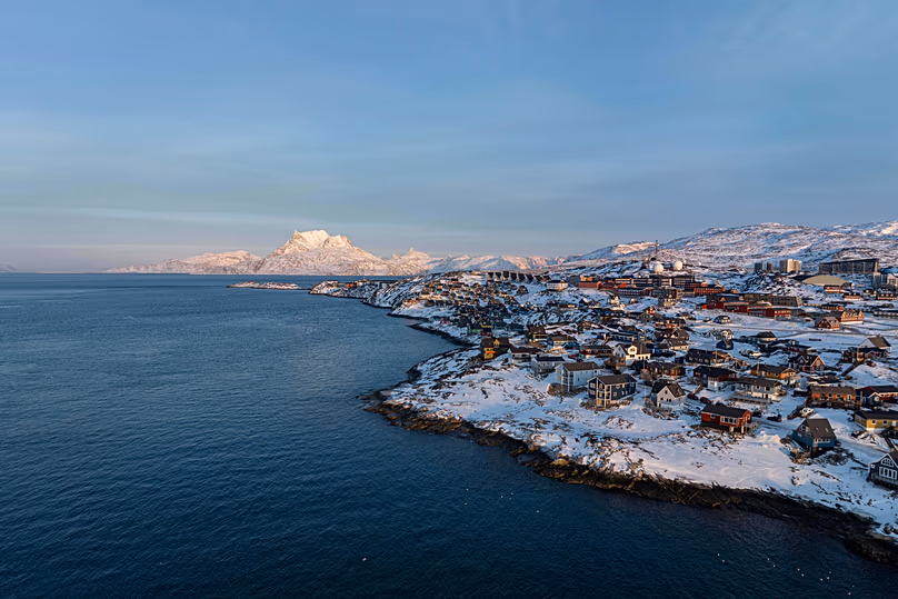 Houses are seen near the coast of a sea inlet of Nuuk, 25 January, 2026