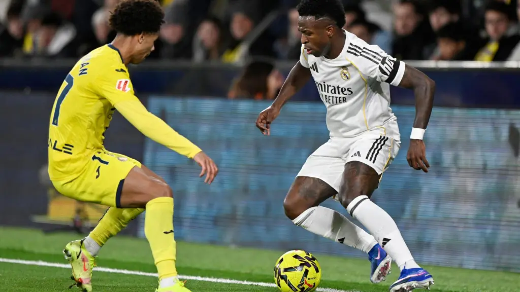 Vinicius encara a Buchanan durante el partido.