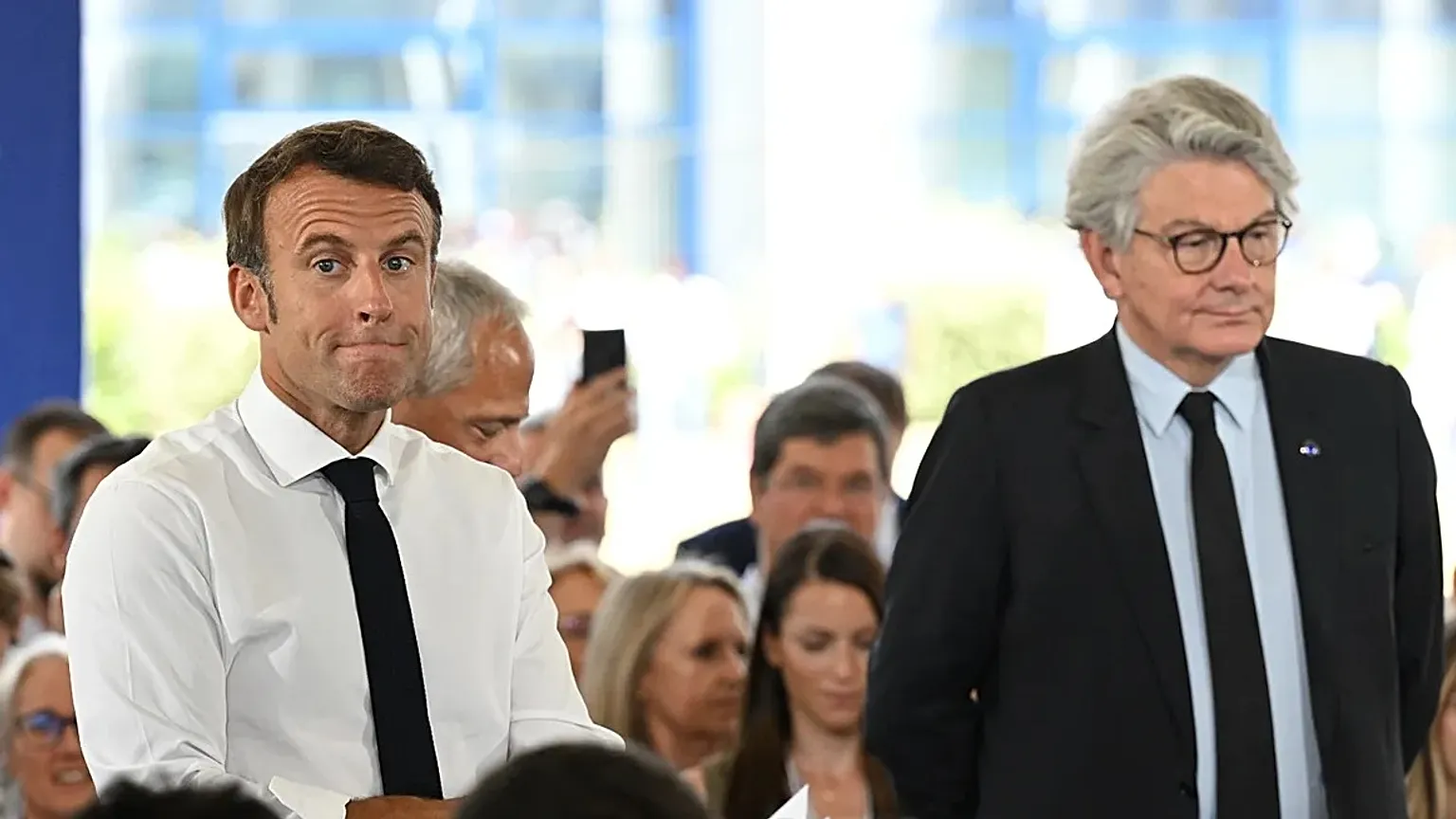 France's President Emmanuel Macron, center, flanked by EU commissioner for internal market Thierry Breton July 12, 2022.