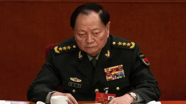 Zhang Youxia, con gesto serio y de preocupación, vestido de uniforme militar