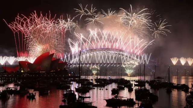 Los fuegos artificiales iluminaron el cielo nocturno sobre el puente del puerto de Sídney y la Ópera de Sídney durante las celebraciones de Año Nuevo en Australia.