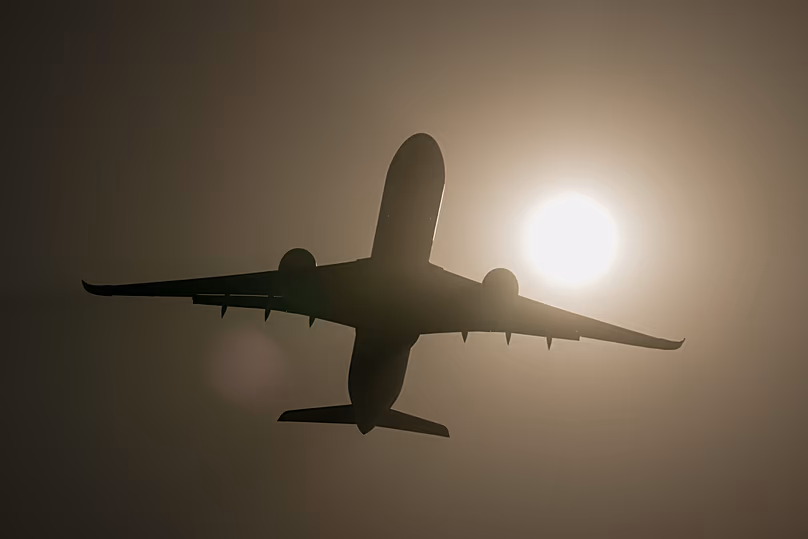 An Airbus A350-1000 is silhouetted against the sun as it performs at the Dubai Air Show, United Arab Emirates, Wednesday, Nov. 19, 2025. 