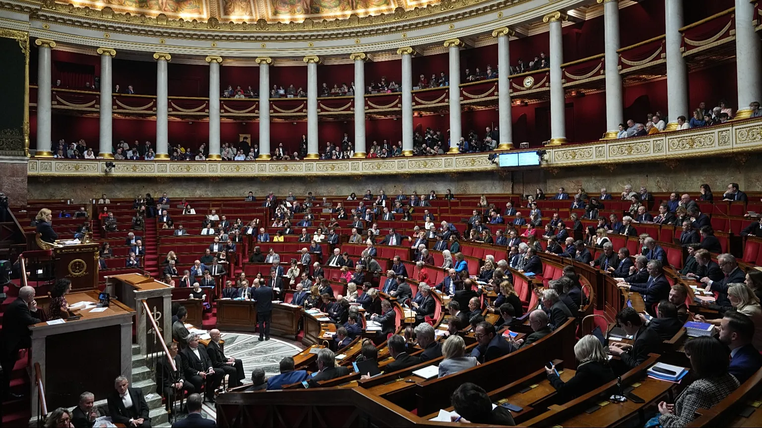 Parliament members sit as France's National Assembly, Dec. 9, 2025. (AP Photo/Michel Euler)