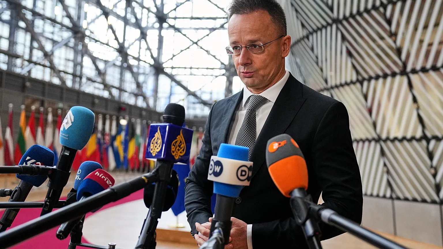 Hungary's Foreign Minister Peter Szijjarto speaks with the media as he arrives for a meeting of EU foreign ministers at the European Council building in Brussels, Monday, Feb.