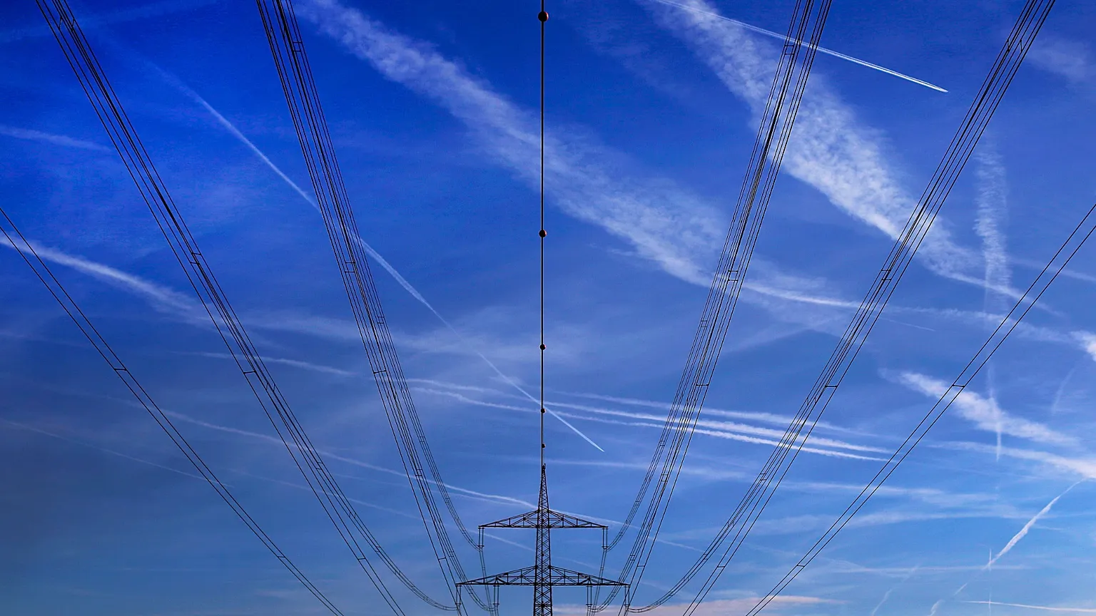 High power cables hang from a pole on a field in Hattersheim, Germany.