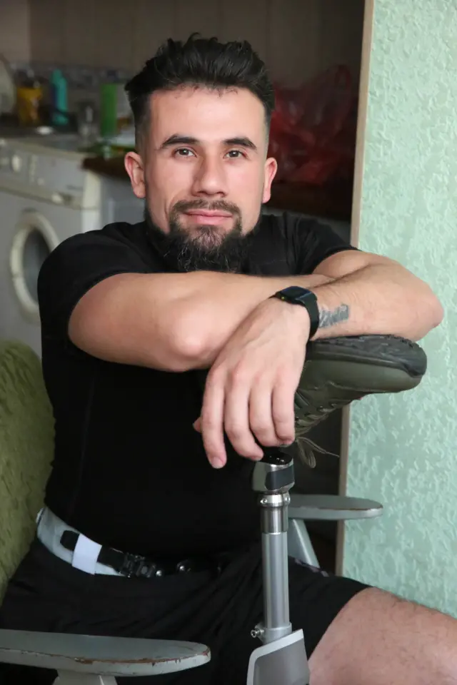 Árabe sentado apoyándose en su pie prostético