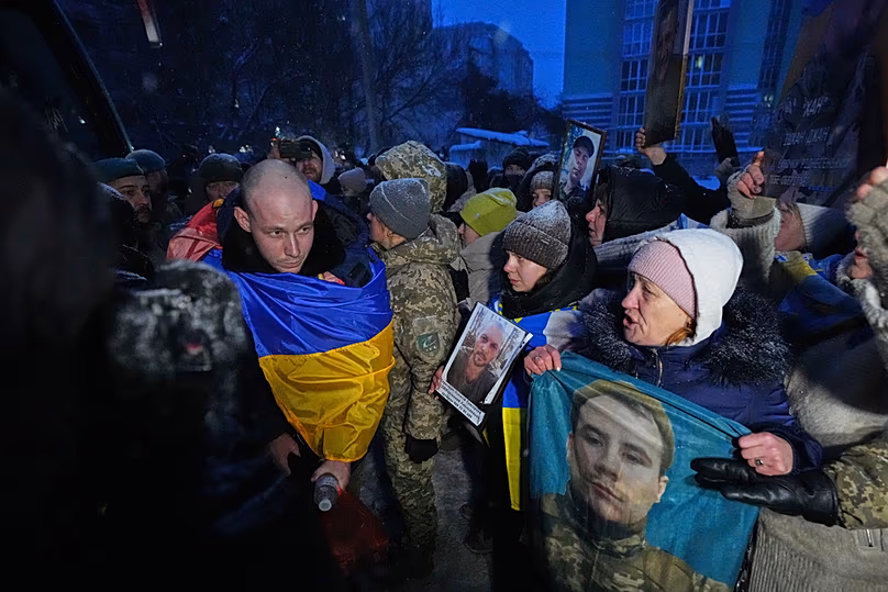 Ukrainian soldier walks in front of a crowd of people after returning from captivity after a POW exchange between Russia and Ukraine, Thursday, Feb. 5, 2026