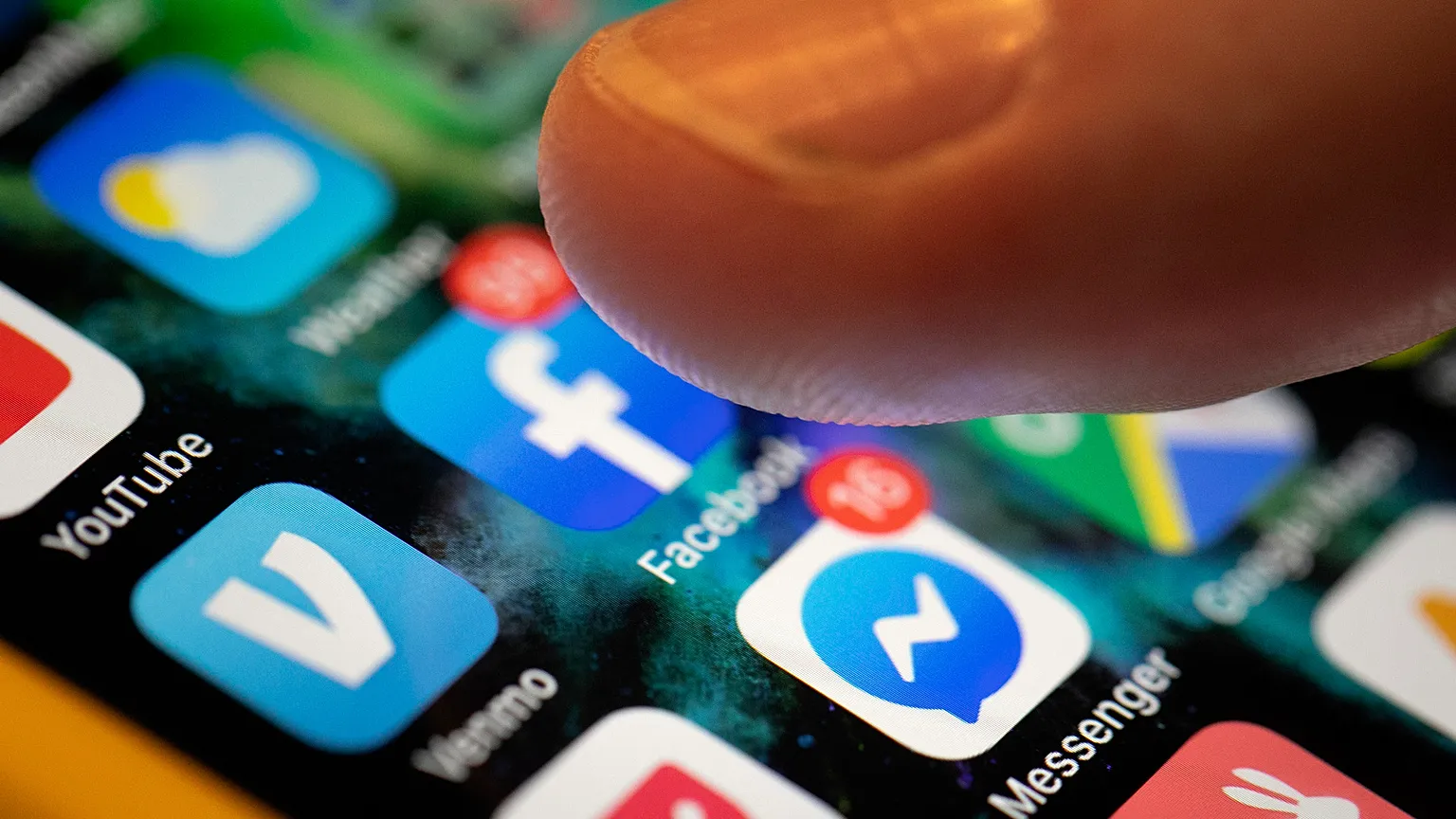 An iPhone displays the apps for Facebook and Messenger