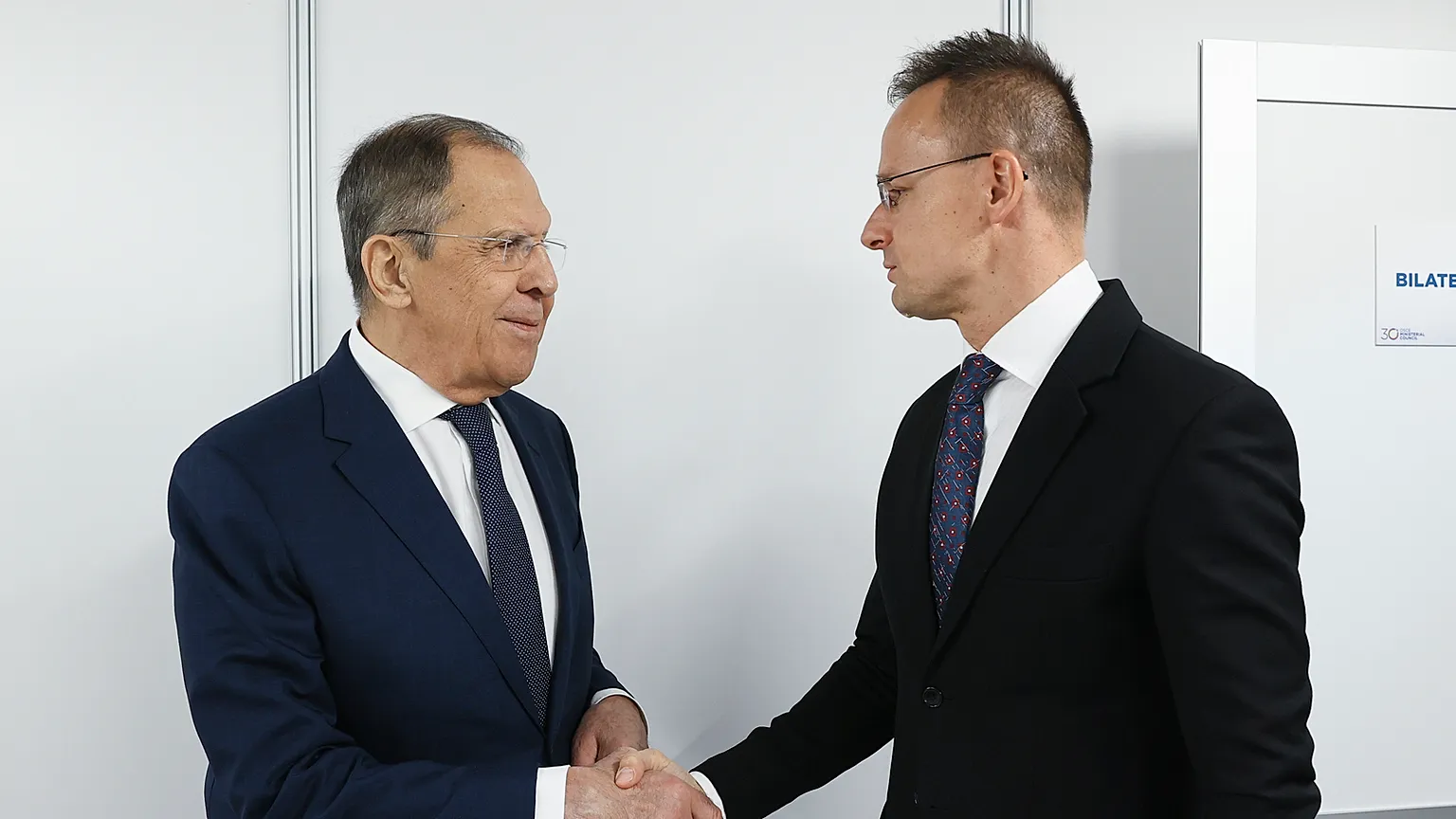 Russian Foreign Minister Sergey Lavrov, left, shakes hands with Hungarian Minister of Foreign Affairs and Trade Peter Szijjarto, Nov. 30, 2023.
