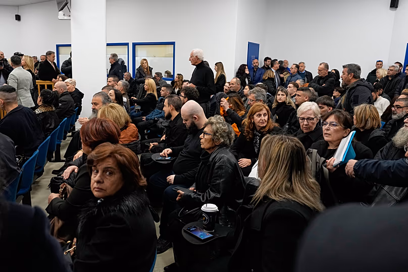 Relatives of victims of the Tempi train crash wait for the start of the trial at the court in Larissa, 23 March, 2026