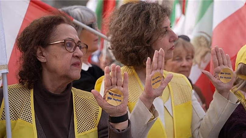 Protesters showing their palms with stickers on them reading “No Shah, No Mullah”, Paris, France, 7 March, 2026.