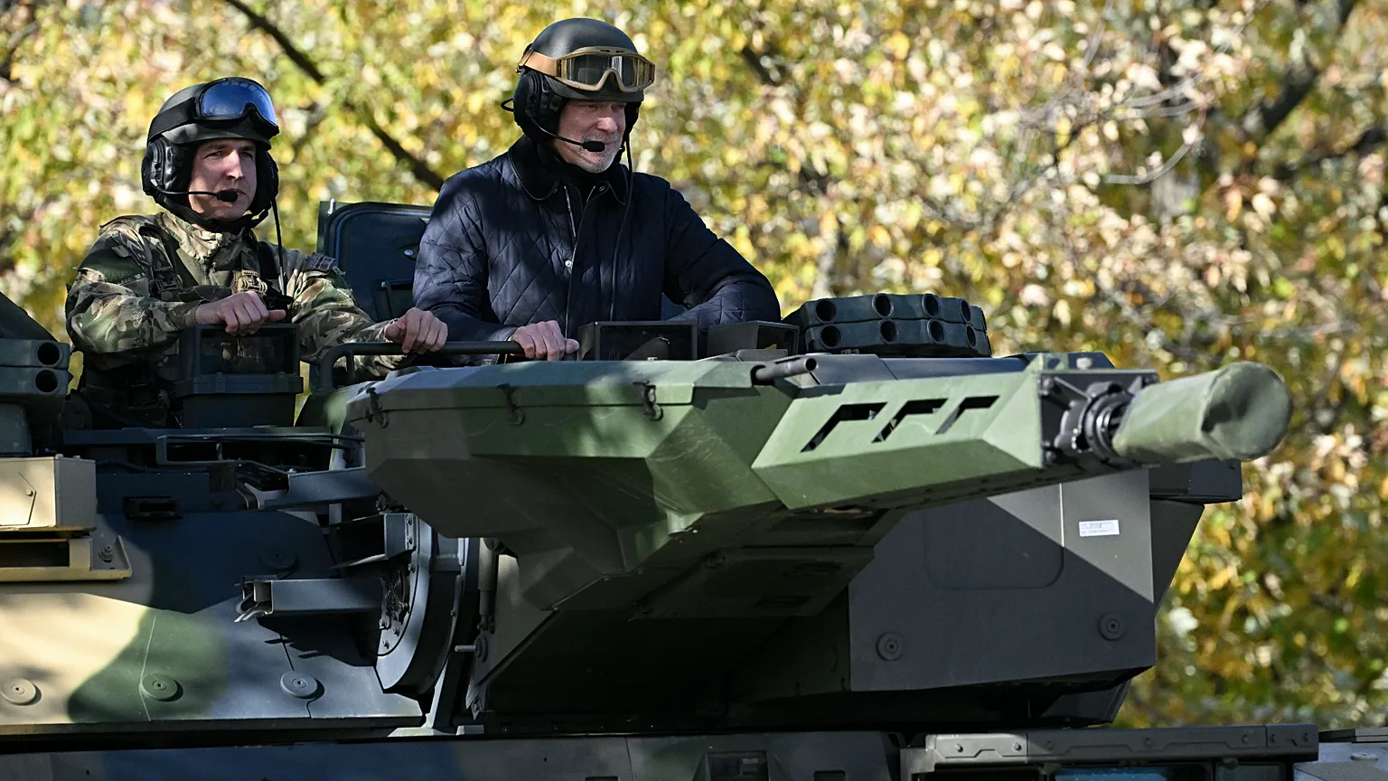Hungarian Minister of Defence Kristof Szalay-Bobrovniczky, right, in a Lynx infantry fighting vehicle 