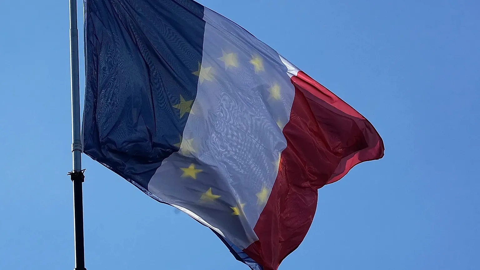 The EU and French flag flap together in the wind prior to leaders arrivals during an EU summit at the Chateau de Versailles.