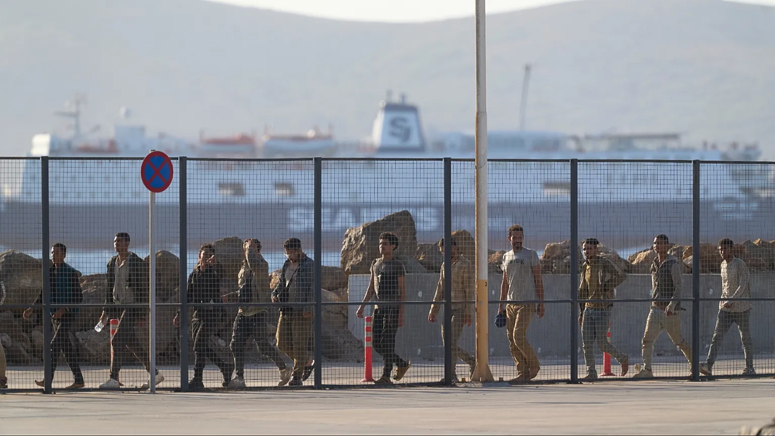 Migrants rescued south of Crete walk after their arrival at the the port of Lavrio, Greece, July 10, 2025. (AP Photo/Petros Giannakouris)