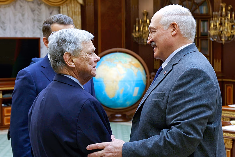Belarusian President Aliaksandr Lukashenka and US envoy John Coale shake hands during their meeting in Minsk, 12 December, 2025