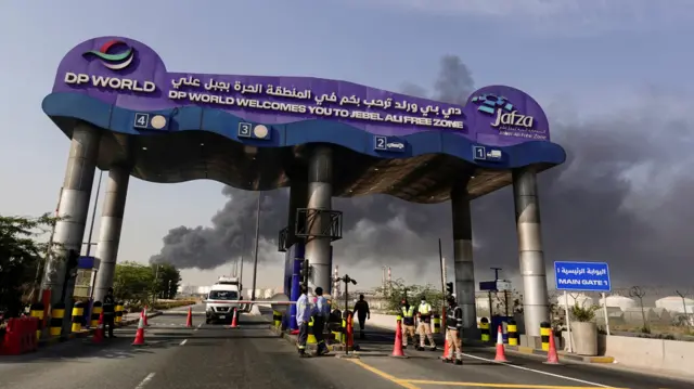 Columnas de humo se elevan detrás de la puerta de entrada del puerto de Jebel Ali.