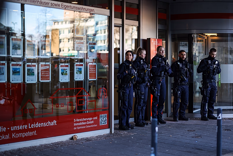 Police officers stand in front of the savings bank branch in the Buer district in Gelsenkirchen, 30 December, 2025 