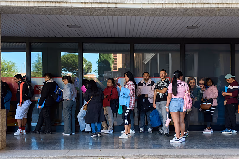 Immigrants queue to request public transport certificate in Madrid, 16 April, 2026