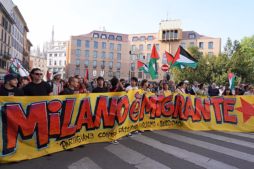 Demonstrators display a banner reading 'Milan is Migrant, Partisans Against Racism, Fascism, ' to protest the anti-migrant rally 'Without Fear in Europe, Milan, 18.04.2026
