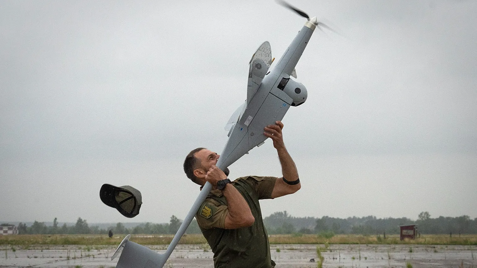 A Ukrainian soldier launches FlyEye WB Electronics SA, a Polish reconnaissance drone.