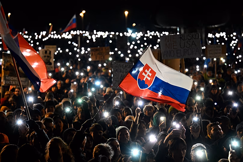 People light up their phones as thousands gather to oppose the policies of Prime Minister Robert Fico in Bratislava, 24 January, 2025
