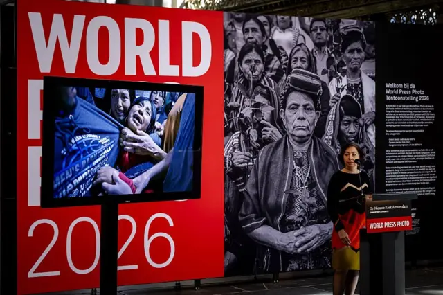 La directora ejecutiva de World Press Photo, Joumana El Zein Khoury, anuncia a la ganadora de la Imagen del Año del World Press Photo 2026, la fotógrafa estadounidense Carol Guzy (su fotografía ganadora se muestra a la izquierda), durante la ceremonia de los World Press Photo Awards 2026, en Ámsterdam el 23 de abril de 2026. (Foto de Robin van Lonkhuijsen / ANP / AFP vía Getty Images)