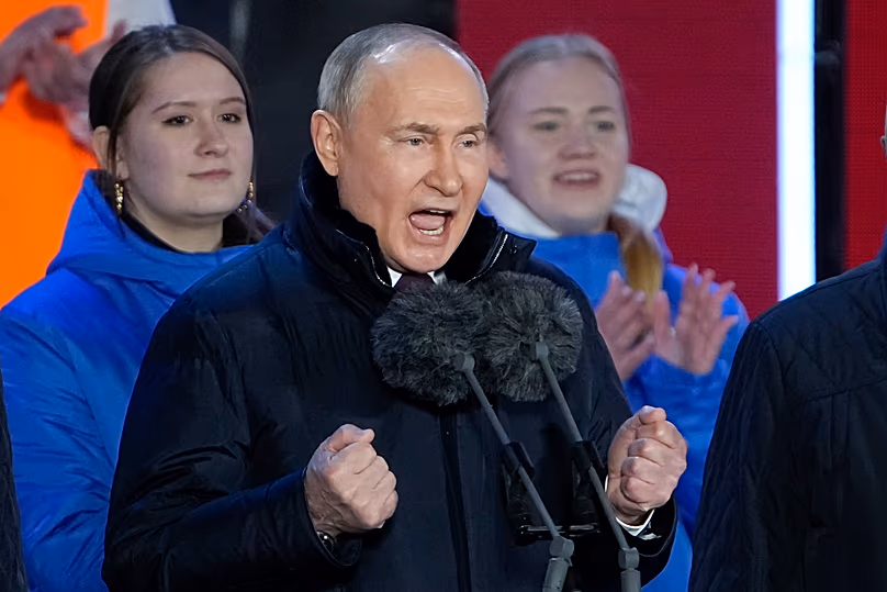 FILE: Russian President Vladimir Putin gestures while addressing a crowd at a concert marking his victory in a presidential election on Red Square in Moscow, 18 March 2024