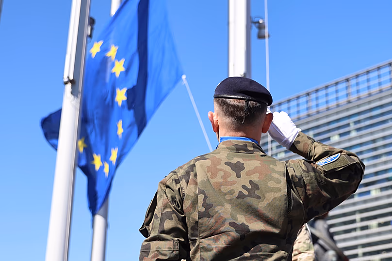 FILE - A Eurocorps soldier salutes the European flag on the 80th anniversary of the end of WWII in Europe, 7 May 2025, at the European Parliament in Strasbourg, France