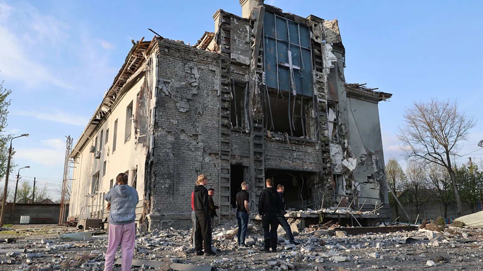 People stand in front of a Baptist church damaged by a Russian-guided aerial bomb in Zaporijjia, Ukraine, Thursday 16 April 2026.