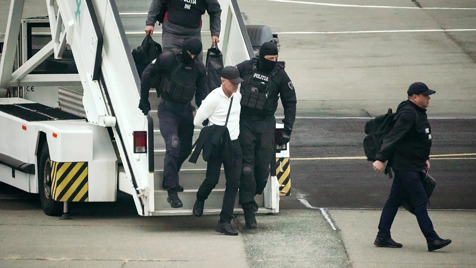 Vladimir Plahotniuc, Moldovan oligarch facing charges over a $1 billion bank fraud, is escorted by police after being extradited from Greece, in Chisinau, 25 September 2025