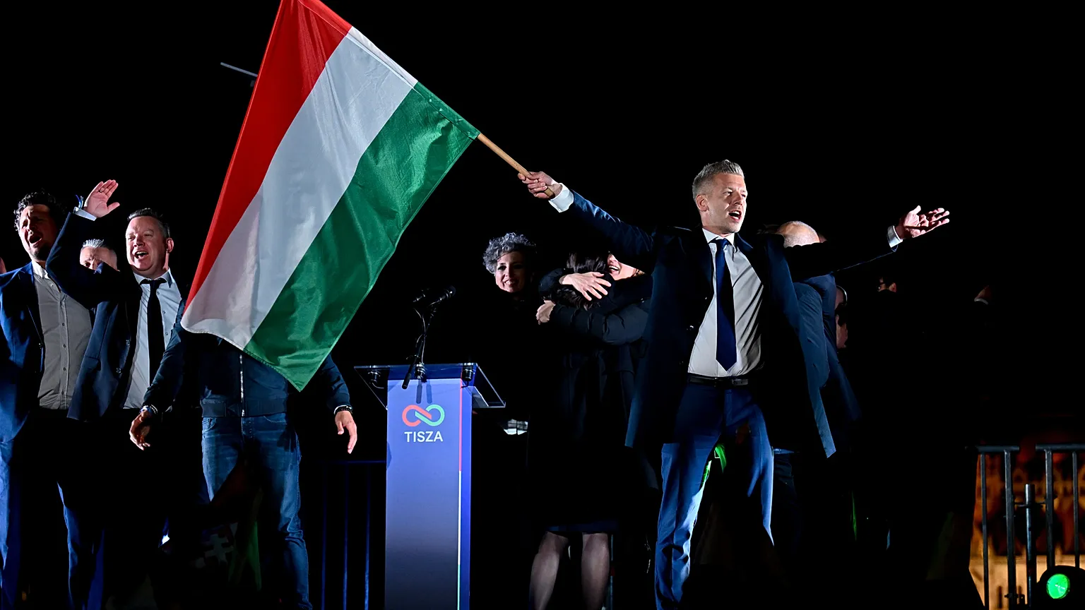 Peter Magyar, leader of the opposition Tisza party, waves the Hungarian flag following the announcement of the partial results of the parliamentary election, in Budapest, Hung