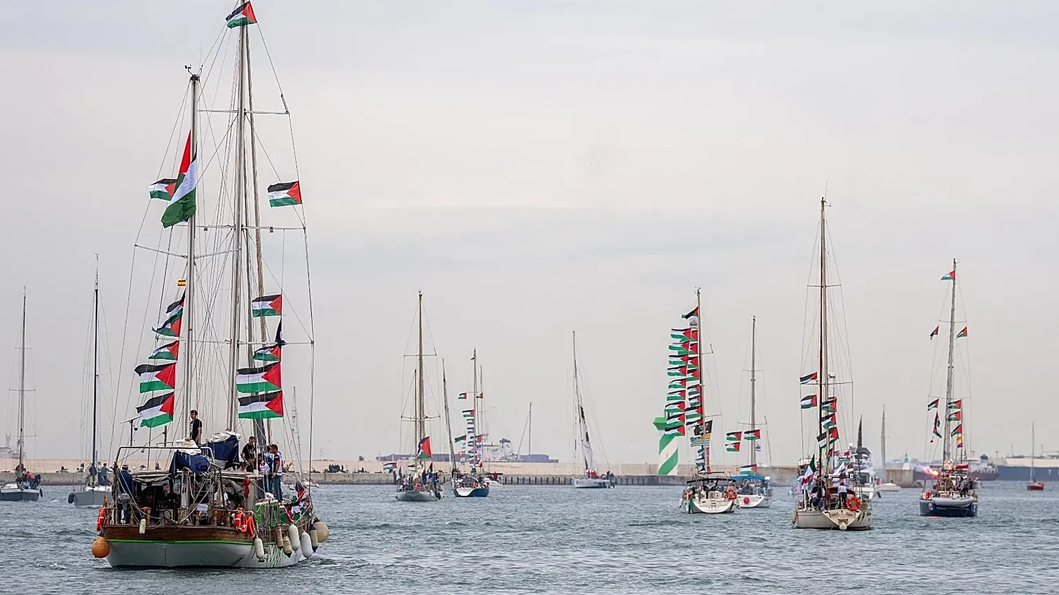 Boats carrying activists and humanitarian aid for Palestinians in Gaza reposition in the port during a symbolic send-off as part of the Global Sumud Flotilla in Barcelona, 12 