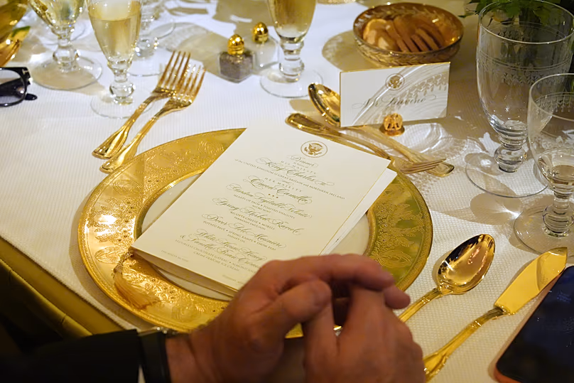A table setting is seen as Britain's King Charles III speaks during a State Dinner in the East Room of the White House State Dinner Tuesday, April 28, 2026, in Washington. 