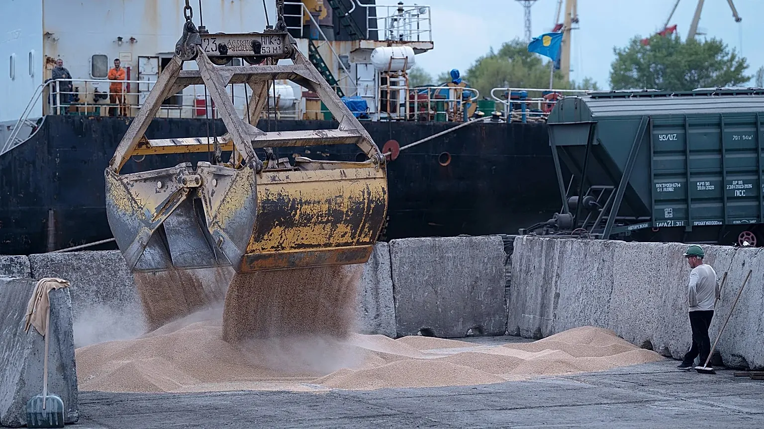 Workers load grain at a grain port in Izmail, 26 April, 2023