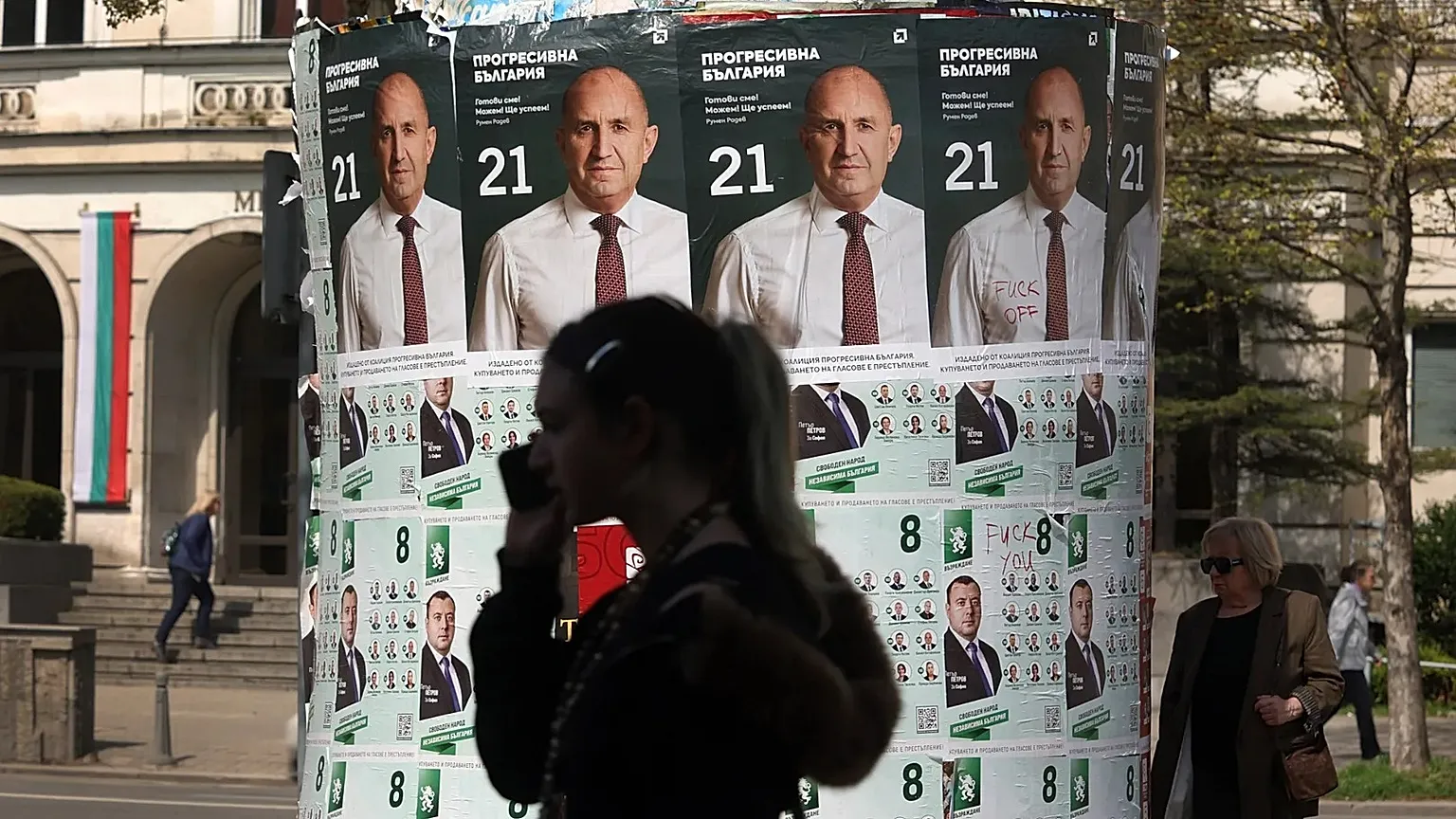 People pass posters of former president Rumen Radev after Bulgaria's parliamentary election in Sofia, 20 April, 2026