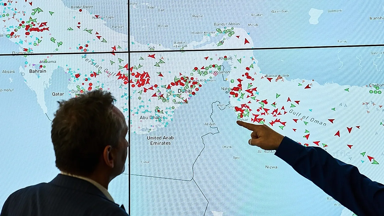Hapag-Lloyd employees monitor the status of cargo ships in the Strait of Hormuz on a screen in Hamburg, 15 April, 2026