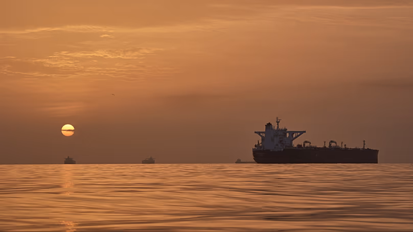 The sun rises behind tankers anchored in the Strait of Hormuz off the coast of Qeshm Island, Iran, Saturday, April 18, 2026.
