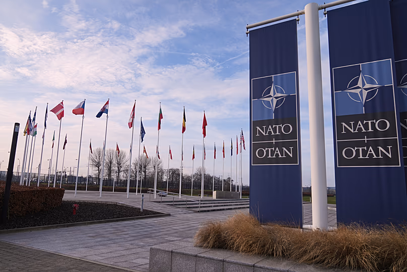 Flags flap in the wind outside NATO headquarters in Brussels, 19 January 2026
