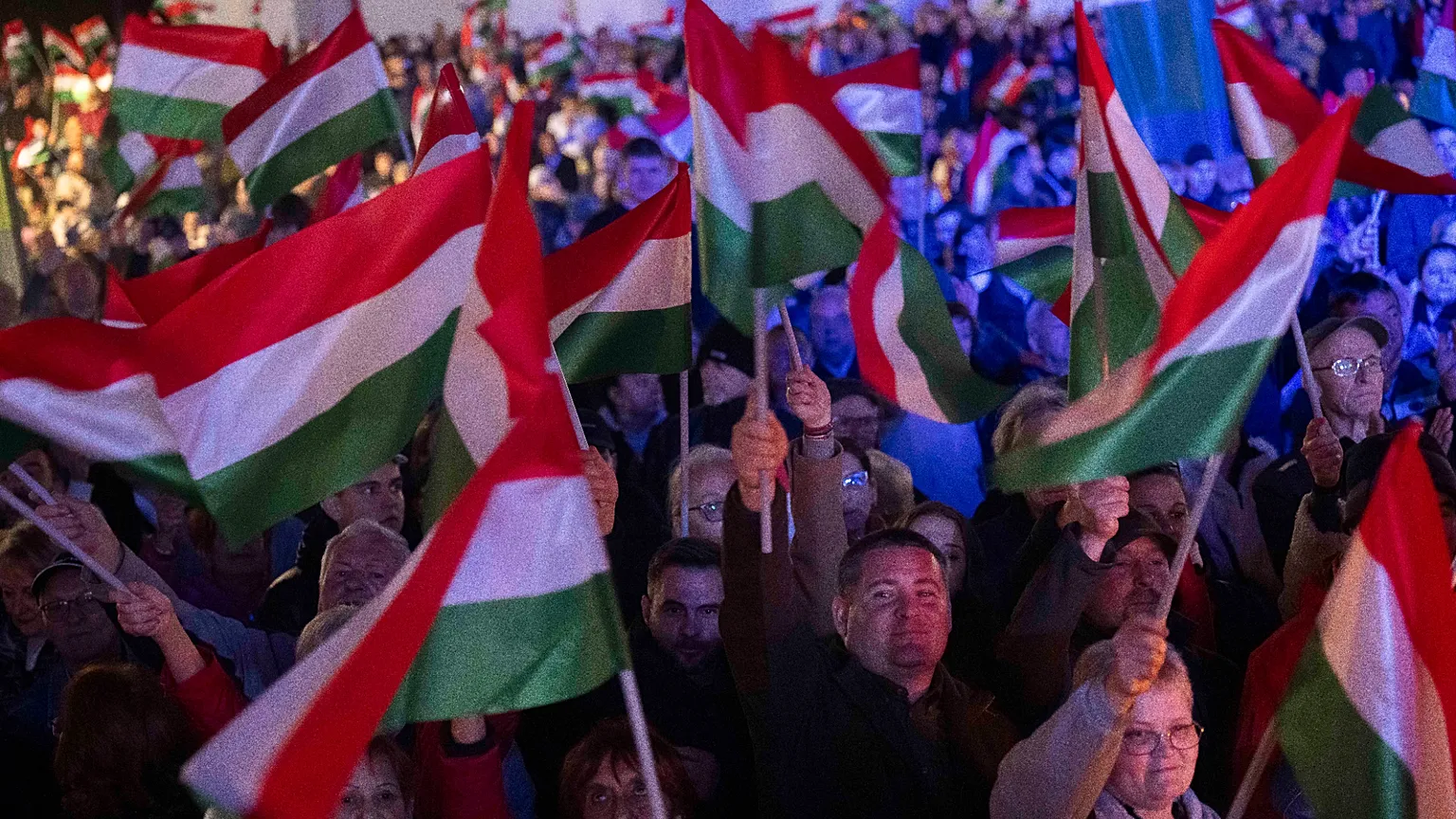 Supporters of prime minister Viktor Orbán wave flags during a countryside campaign tour in Kaposvár, Hungary, Monday, March 16, 2026 ahead of April 12 parliamentary election.