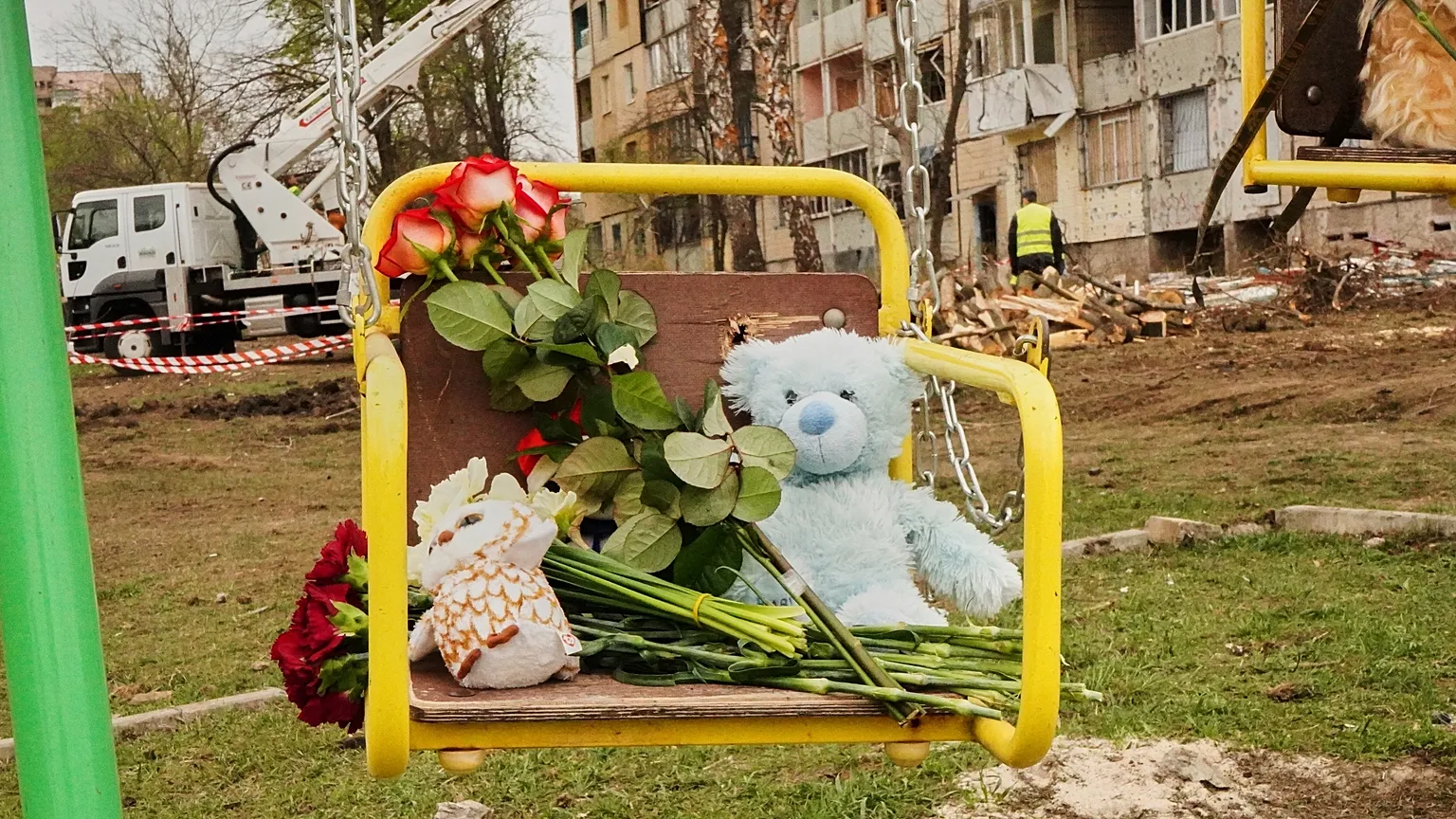 FILE: Flowers and toys left on a swing to commemorate victims killed in Russia's missile attack at a play area near damaged apartment buildings, in Kryvyi Rih, 5 April 2025
